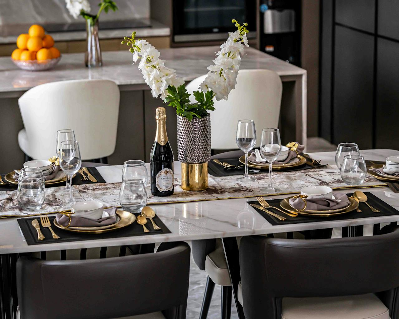 brand-02 Luxurious dining table arrangement with elegant decor and floral centerpiece in a modern home.