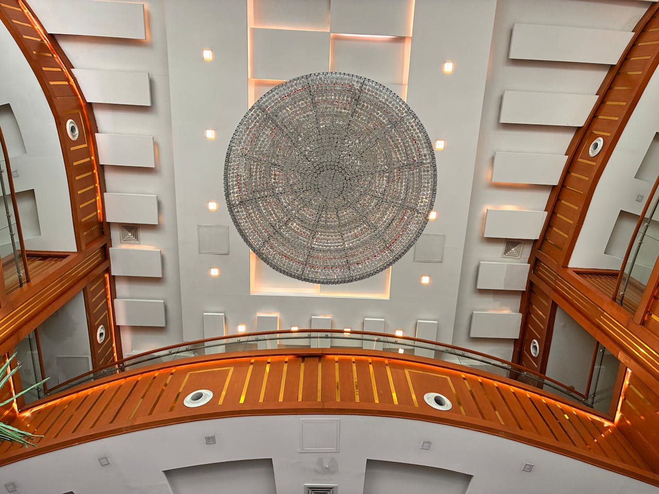 Captivating view of modern architecture featuring a large circular ceiling design with elegant lighting.