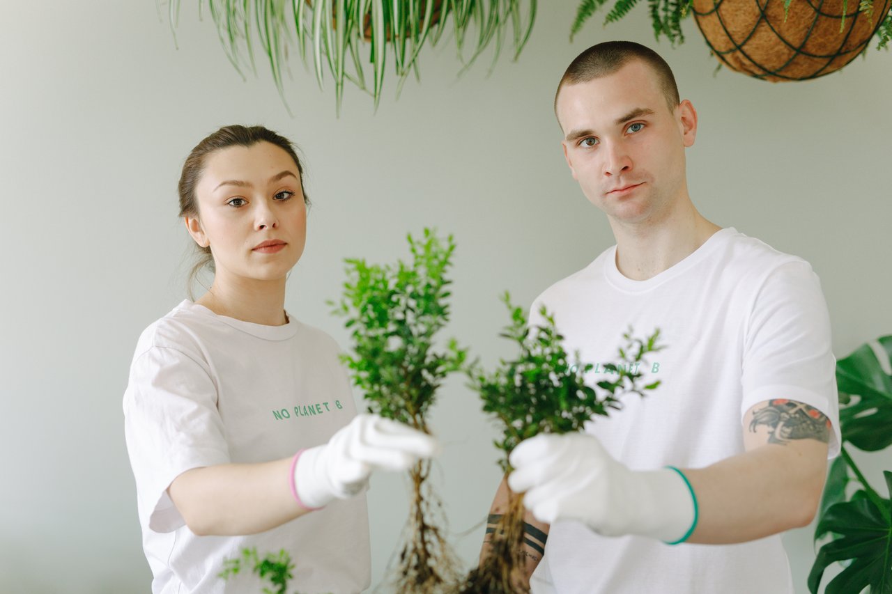 creative-02 A young couple engaged in eco-friendly planting indoors, promoting environmental awareness.